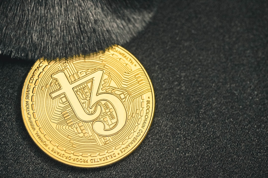 a close up of a gold coin on a black surface