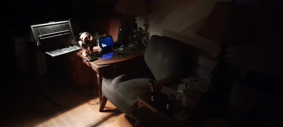 A dimly lit room with a desk and chair.